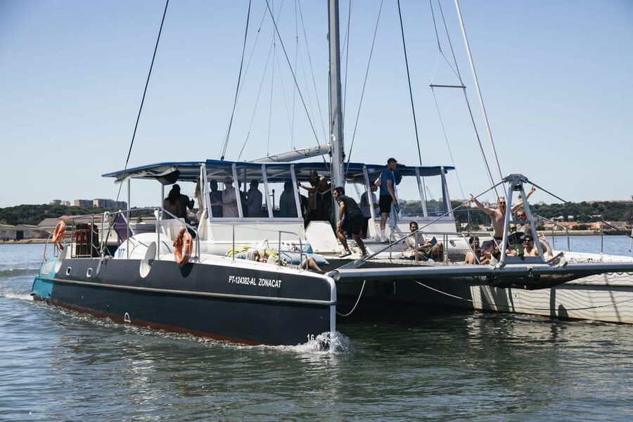 Lisbon: Catamaran Boat Party with Music, Open Bar & Dives - Setting out from Doca de Santo Amaro