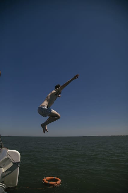 Lisbon: Catamaran Boat Party with Music, Open Bar & Dives - The water stop and ladder access